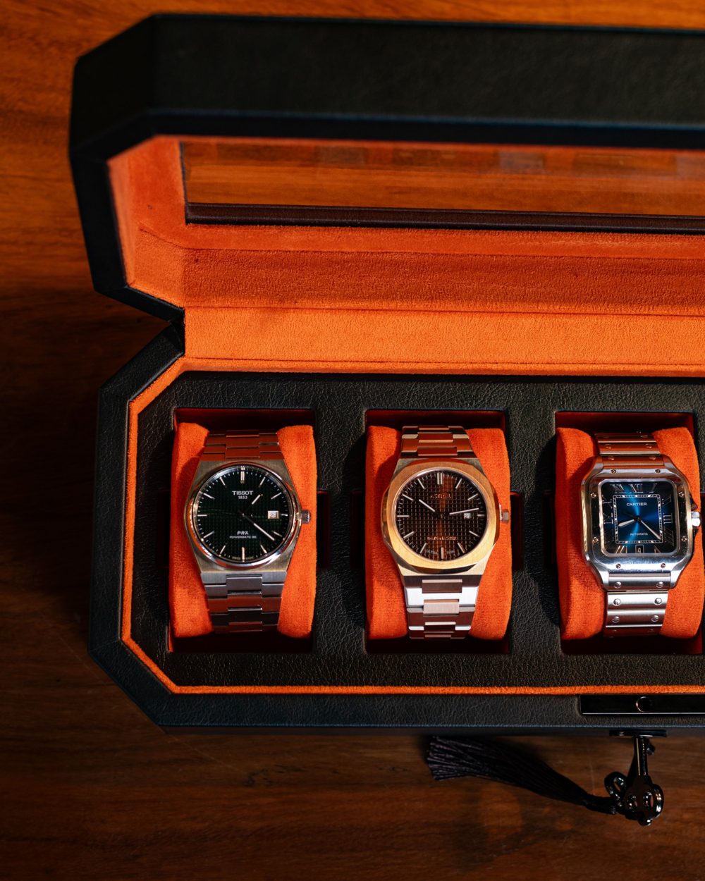 Close-up of watches on orange cushions inside The Duchess with its key