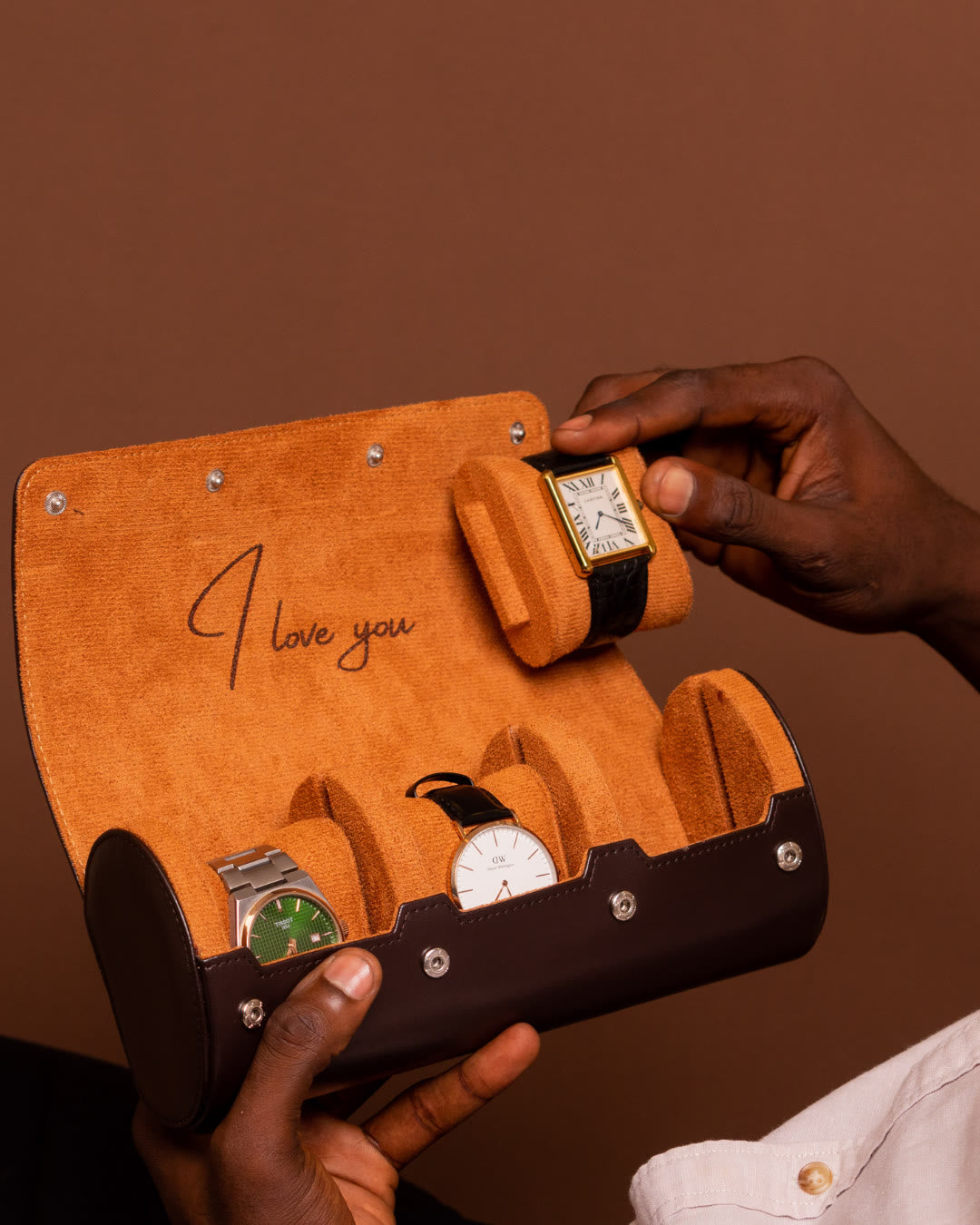 Hands holding an open LWR watch roll with I love you engraved inside